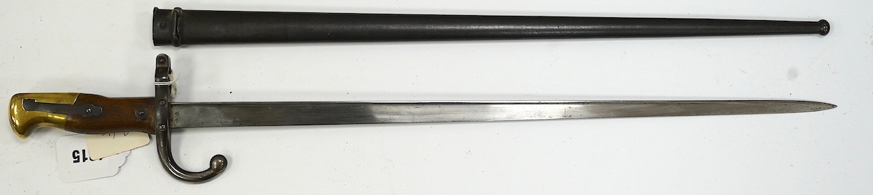 An 1875 French T-section bayonet in its steel scabbard for a Gras rifle, with engraving in French to the top of the blade. Condition - good